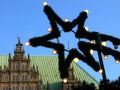 Der Bremer Weihnachtsmarkt auf dem historischen Marktplatz - ein Weihnachtsstern vor der Rathaus-Fassade